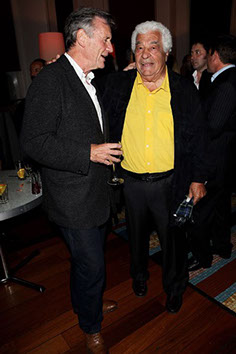 Antonio Carluccio talks with Michael Palin while holding Italian Tartan scarf in his left hand at his new book launch