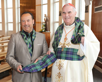 Cardinal O'Brian of Glasgow being presented with scarf and cummerbund made out the St Ninians Day tartan by Clan Italia for the Papal Visit 2010